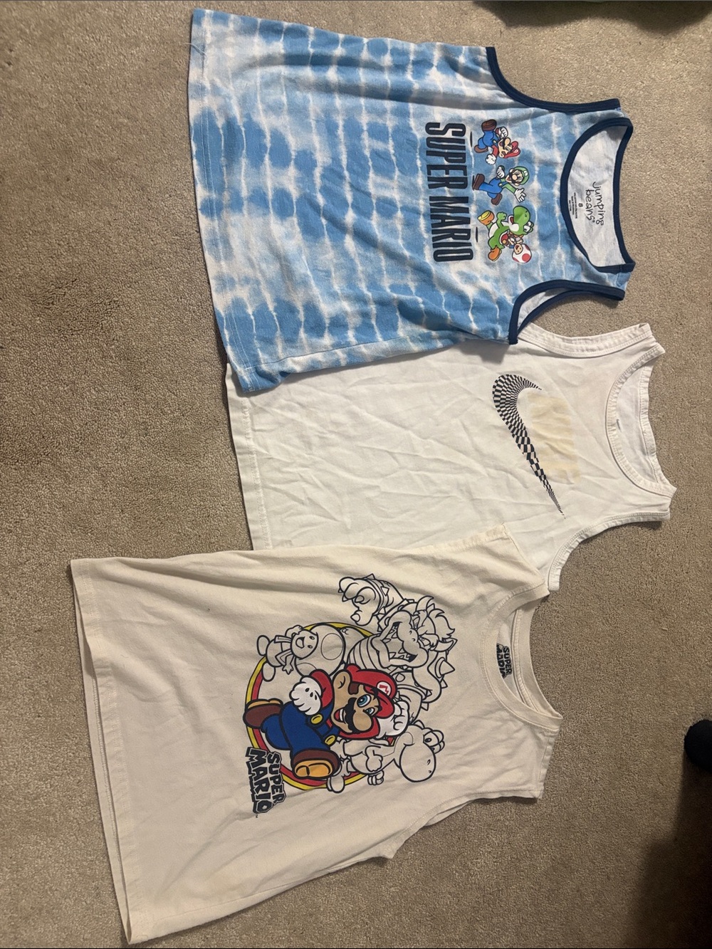 Nike Tank Top with Black Swoosh Logo color changing in sun and two Mario tanks